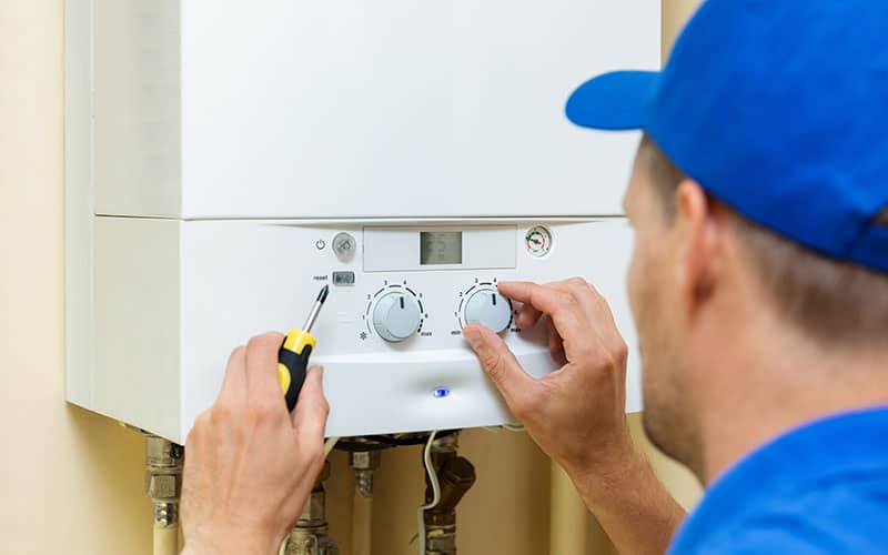 Plumber working on boiler